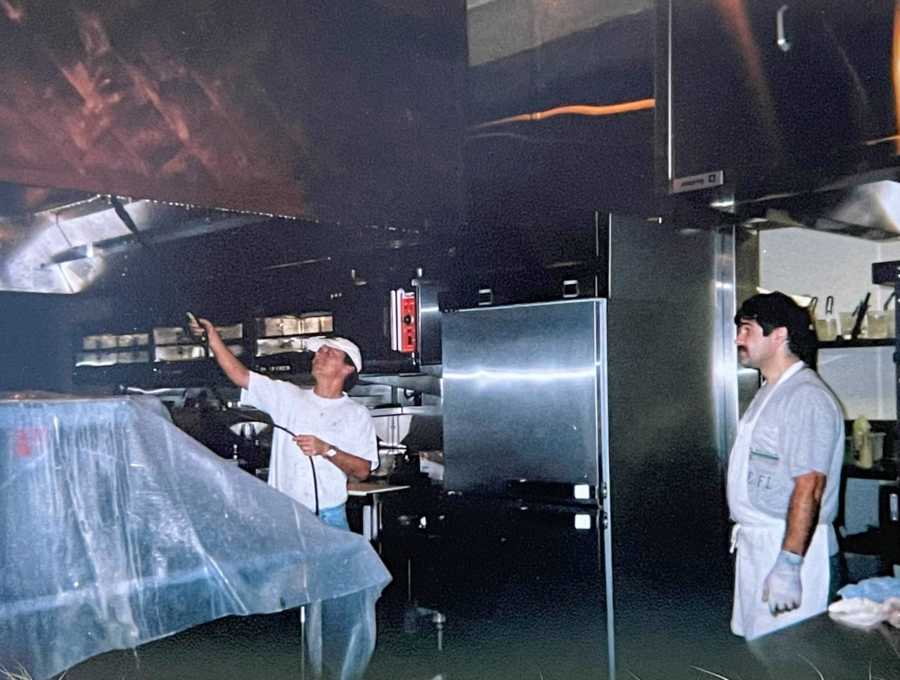 Man who owns his own janitorial business works hard to clean up an restaurant