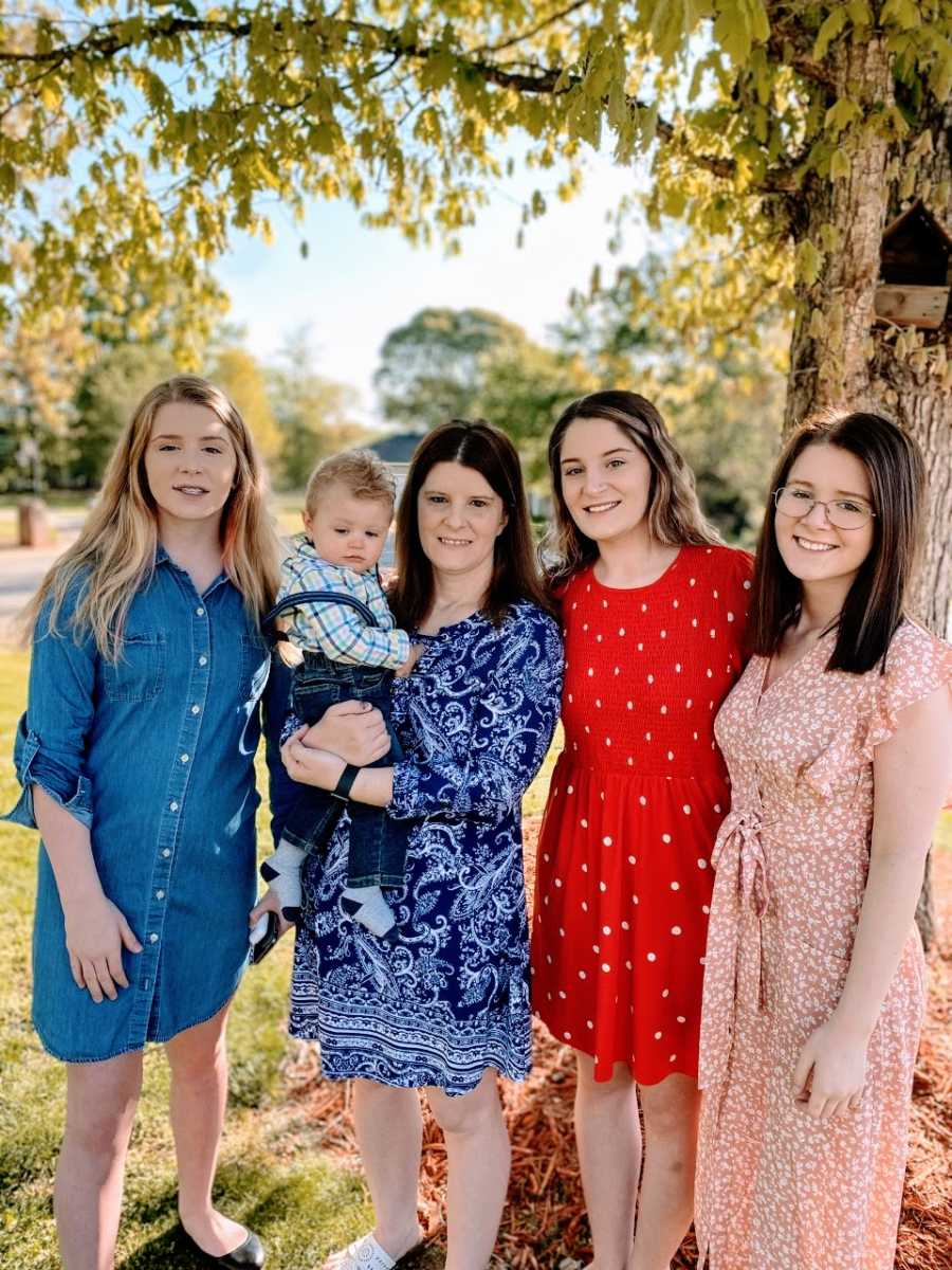 Mom takes a photo with her three daughters and adopted son after church service on Sunday