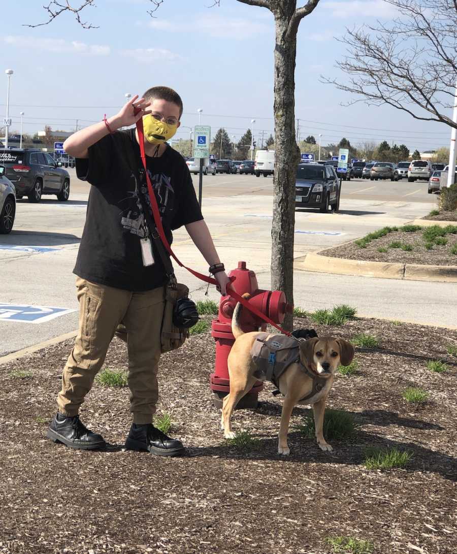 person walking dog with mask on