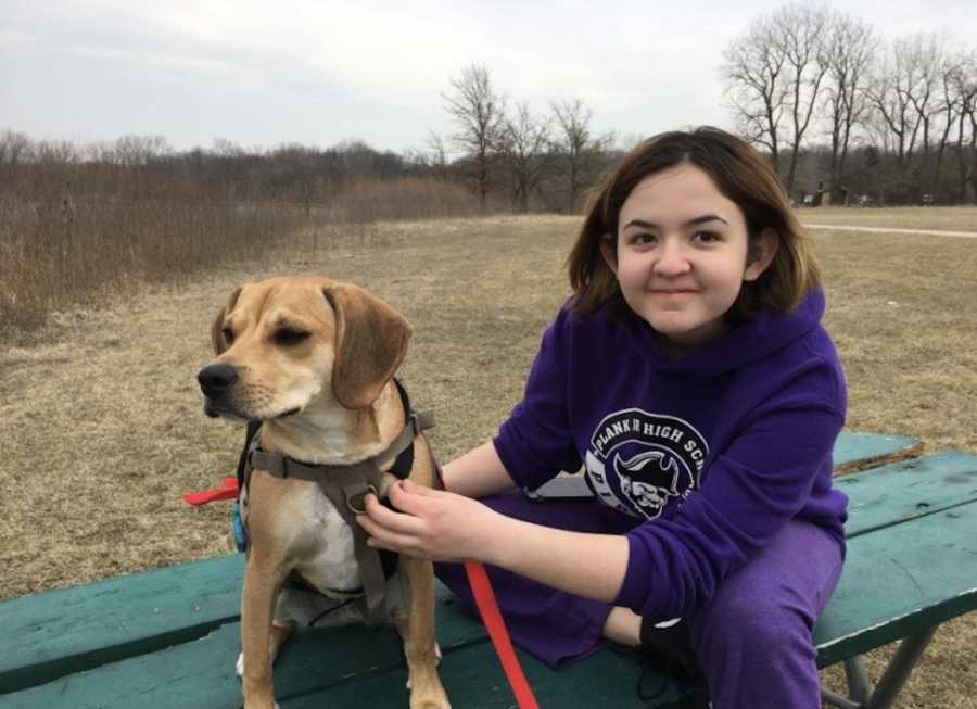 person on bench with dog