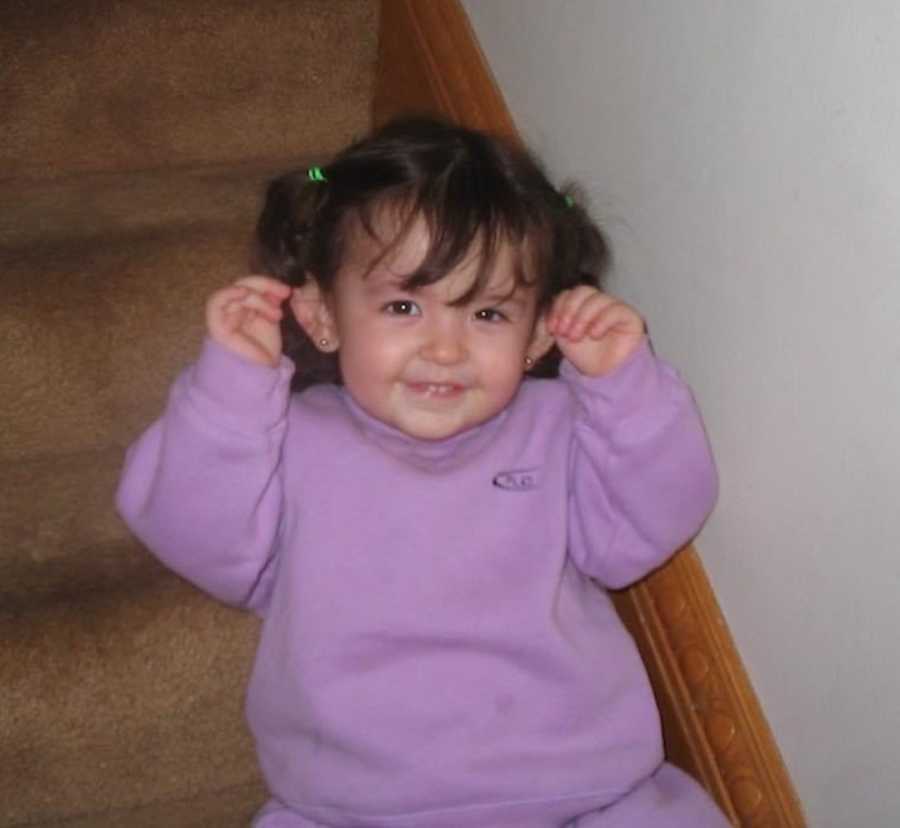 young kid on stairs smiling