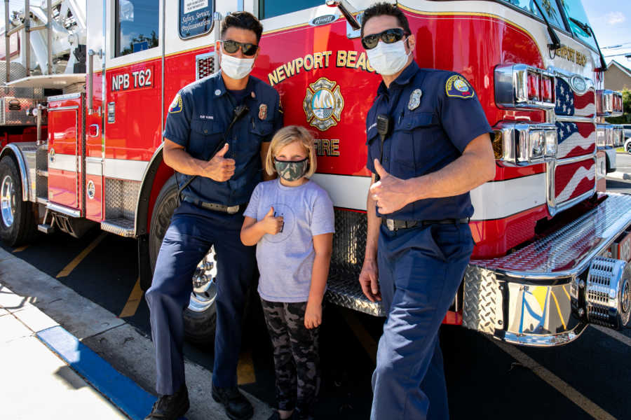 masked girl with two firefighters