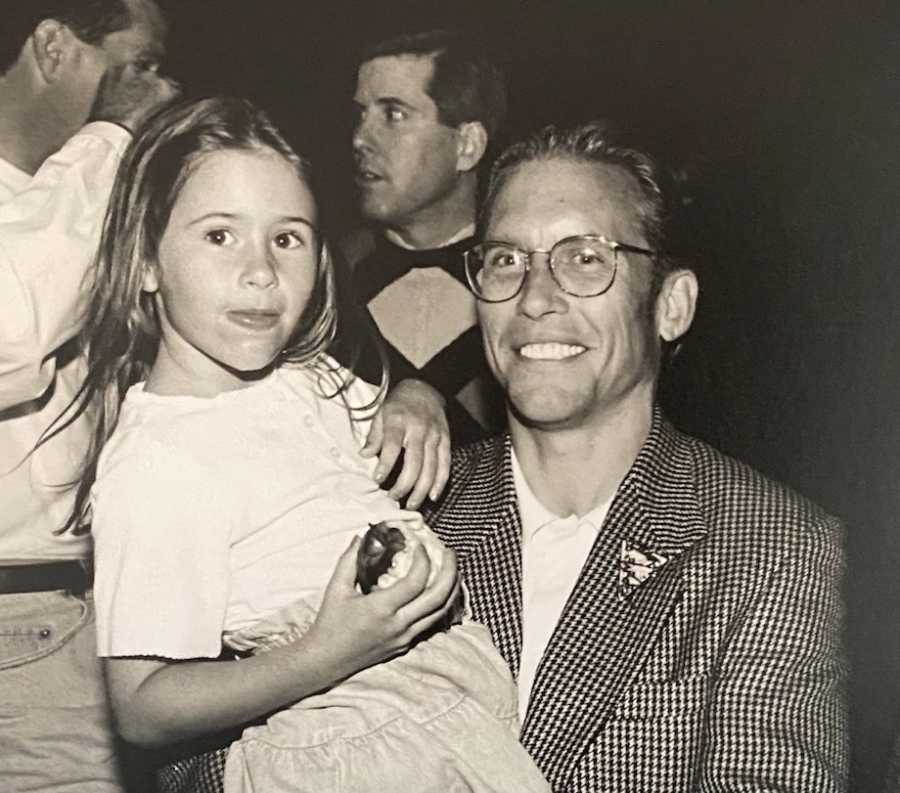 Black and white photo of dad holding daughter