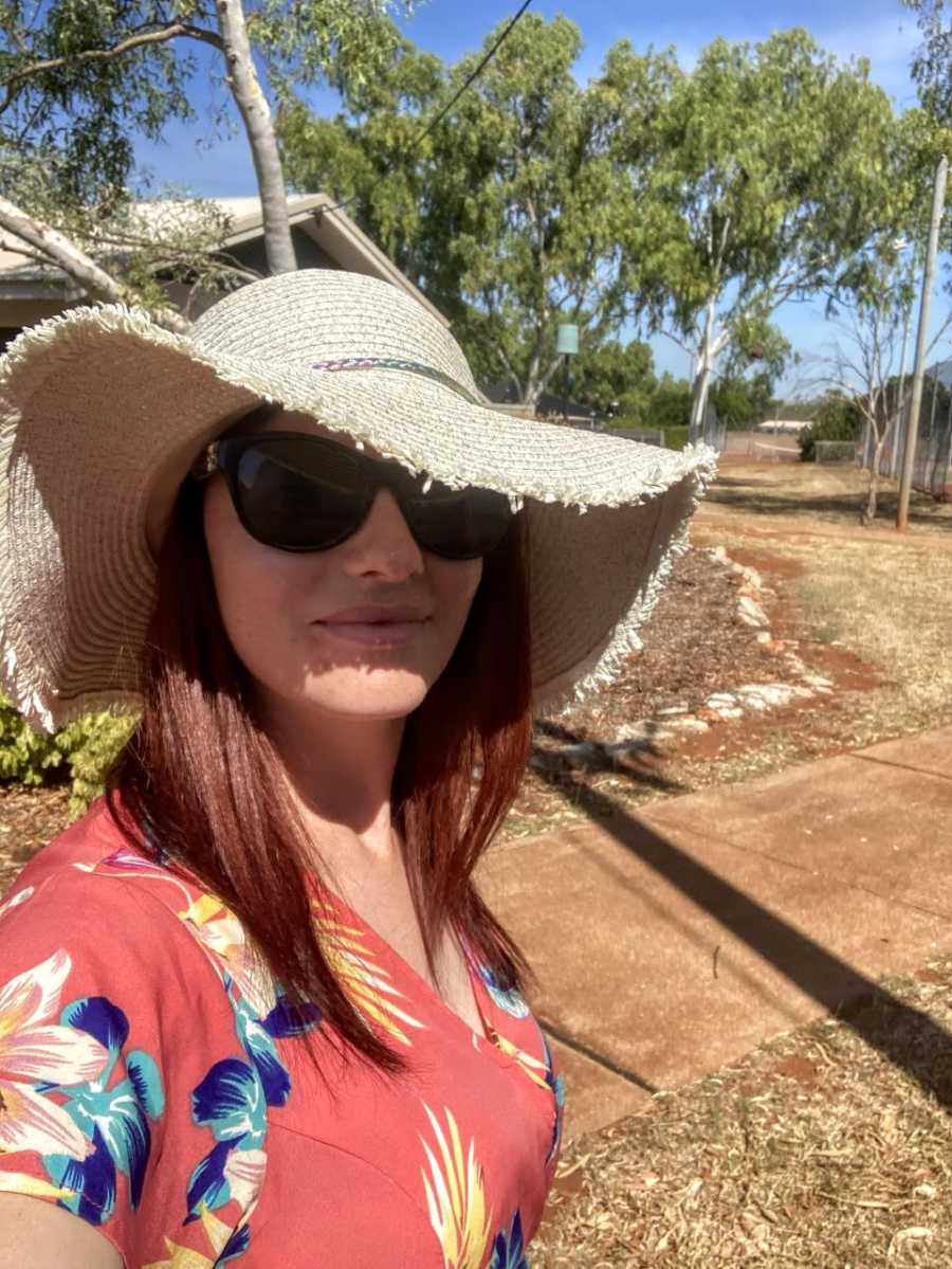 Mom takes a selfie in a sun hat during her nature walk with her children