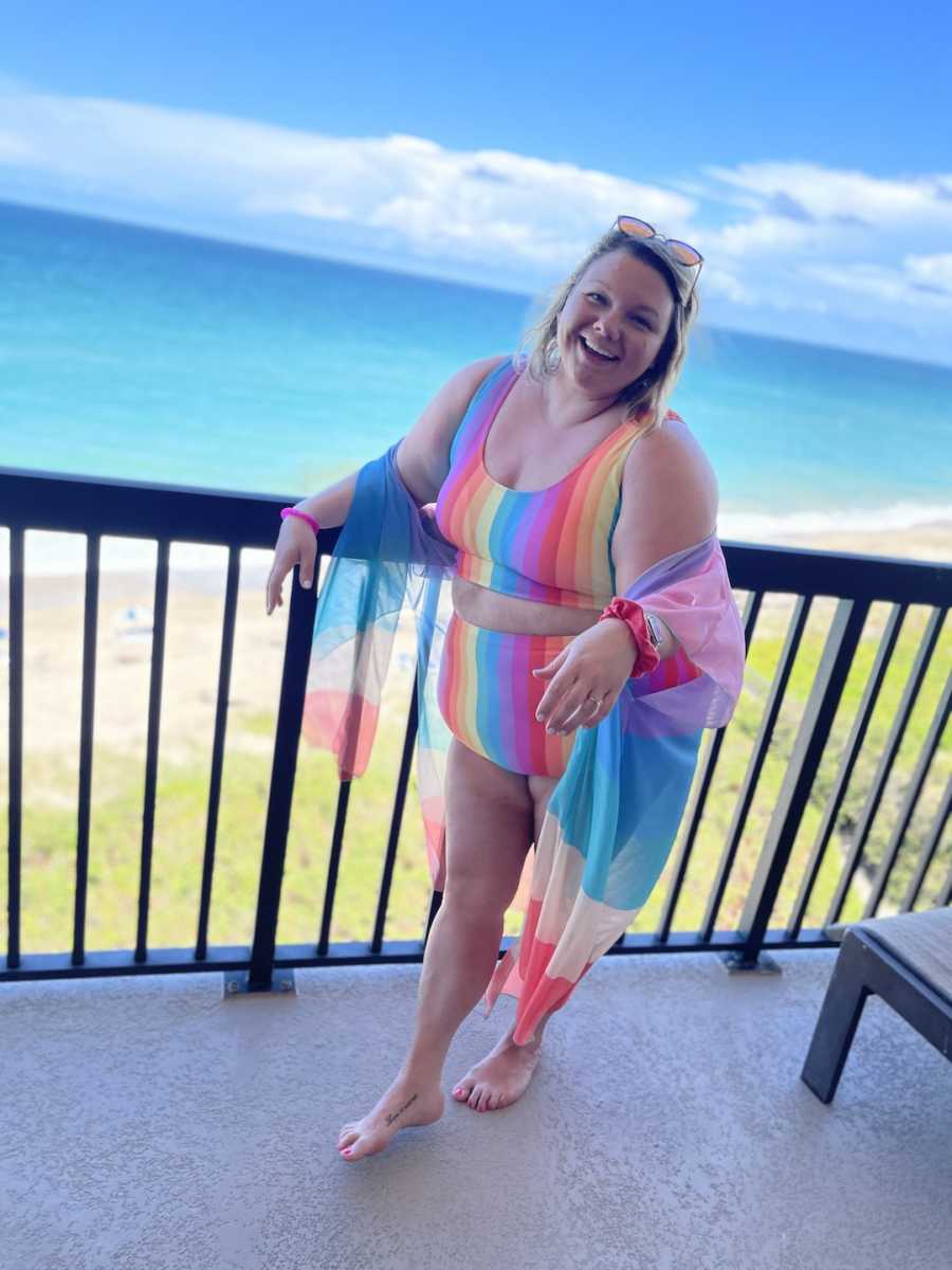 young woman posing in bathing suit on balcony