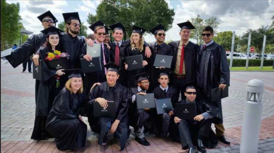 group of college graduates in caps and gowns