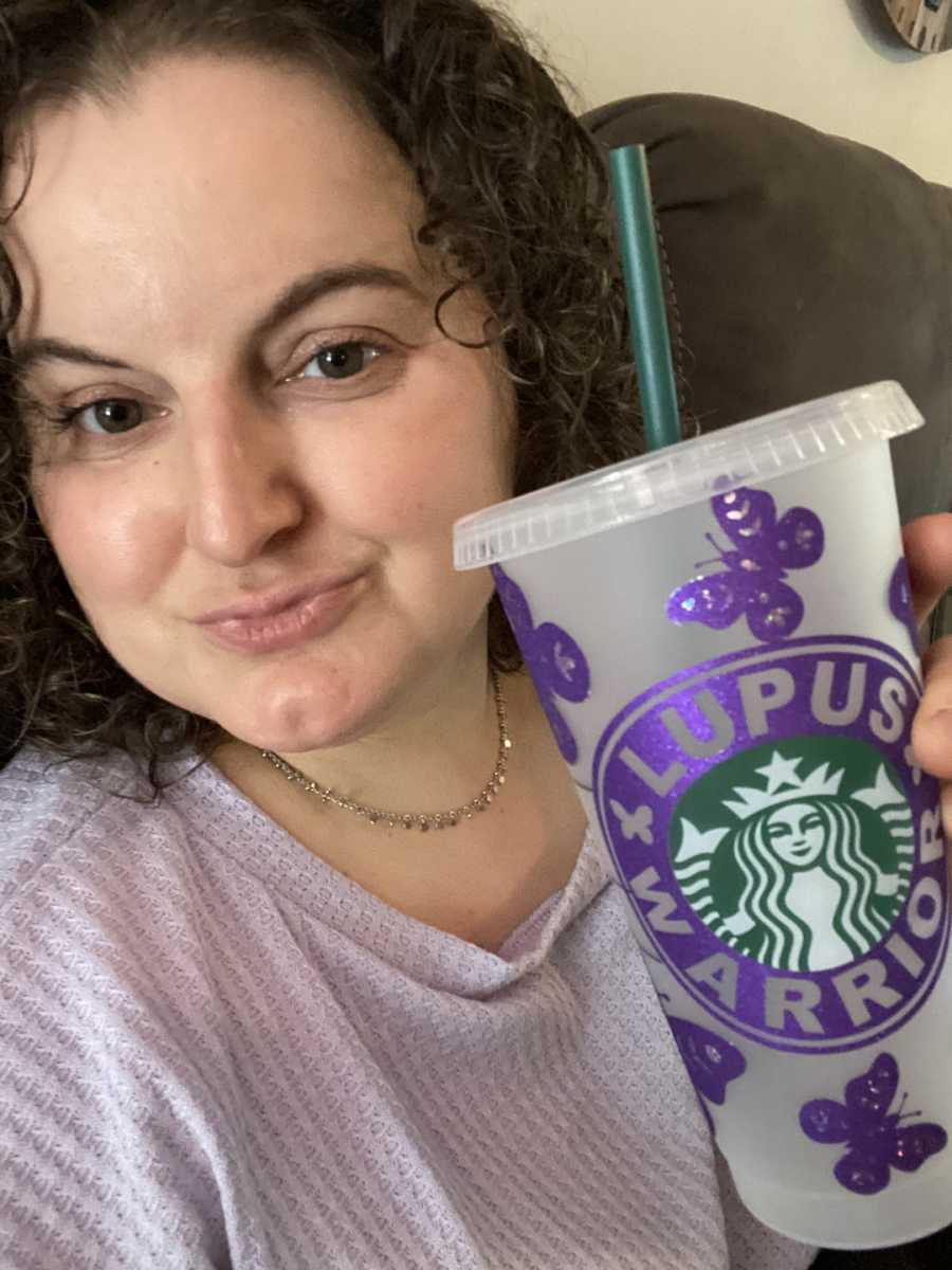 woman with purple "lupus warrior" starbucks cup