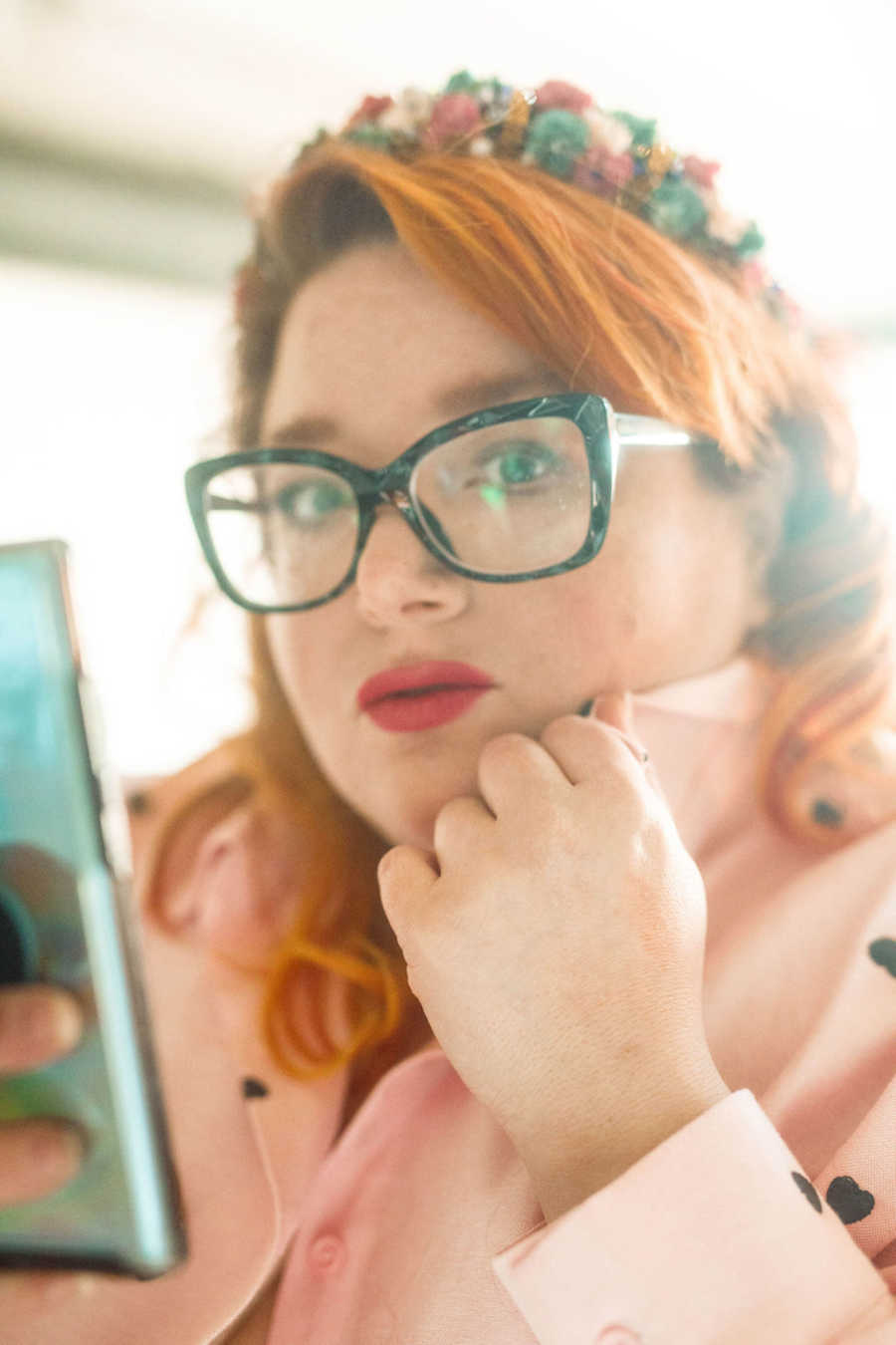 Redhead woman with glasses wearing flower crown