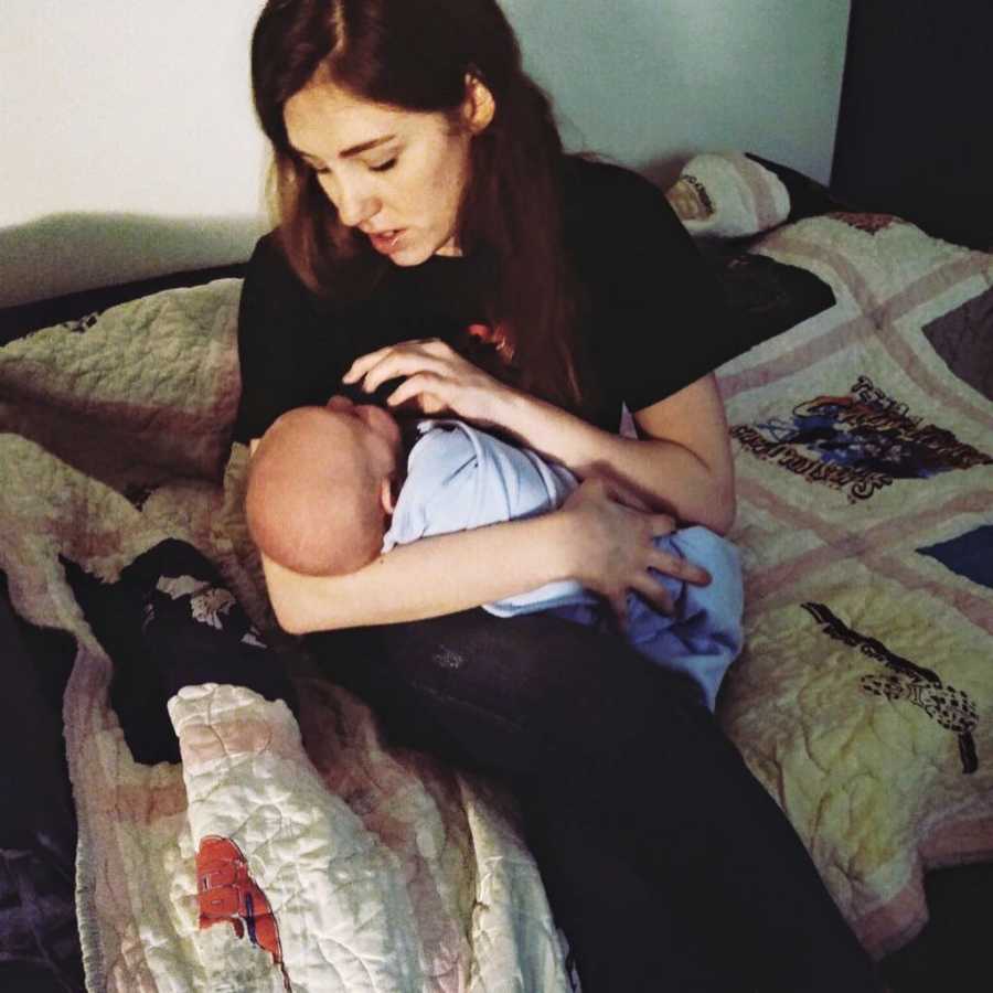 New mom comforts her newborn with a pacifier while rocking him