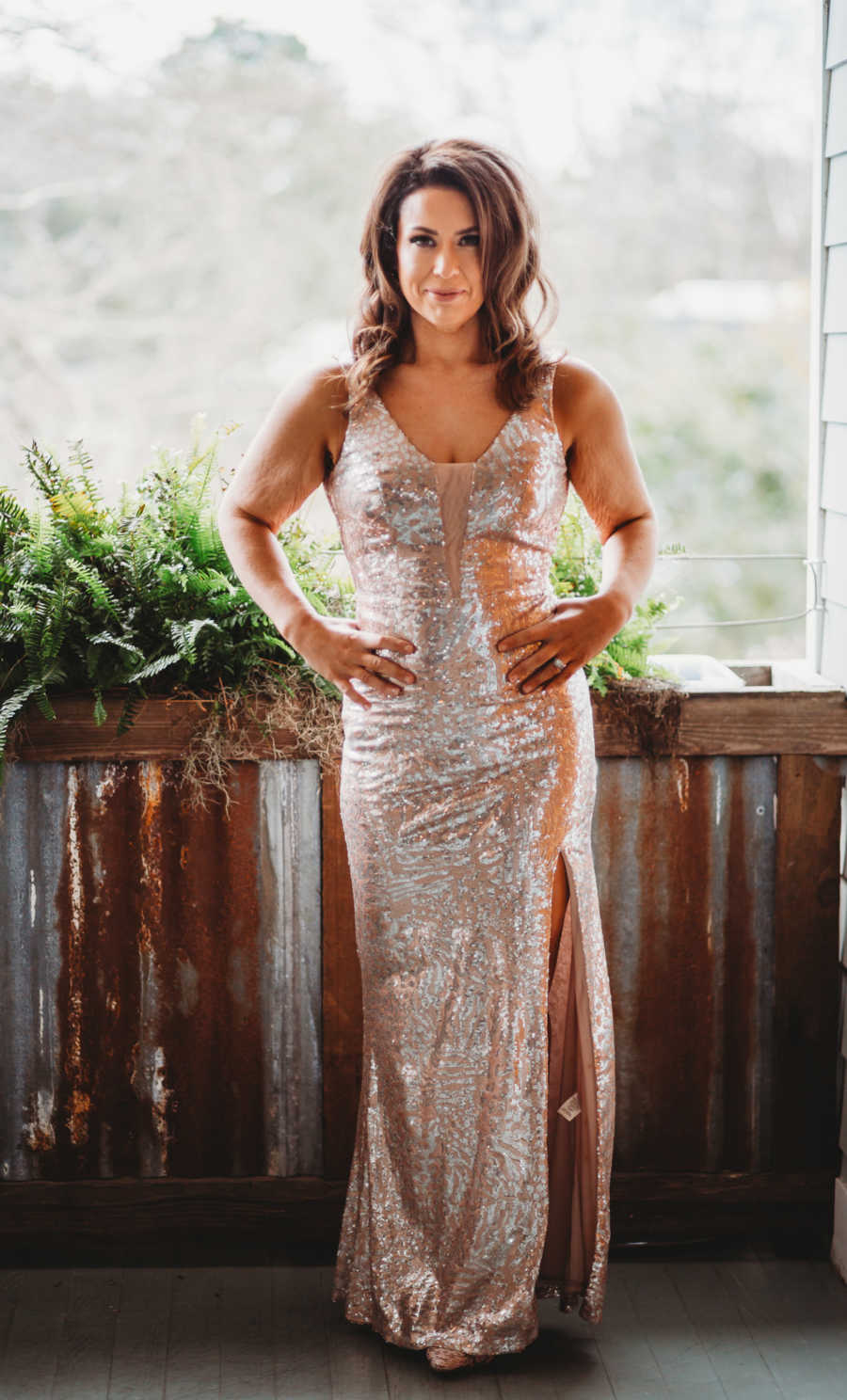 Woman takes photos in skin-tight sparkly gold dress, looking confident after weight loss journey