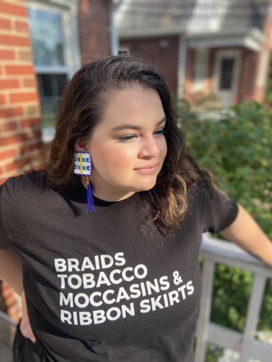 girl in Native American pride shirt