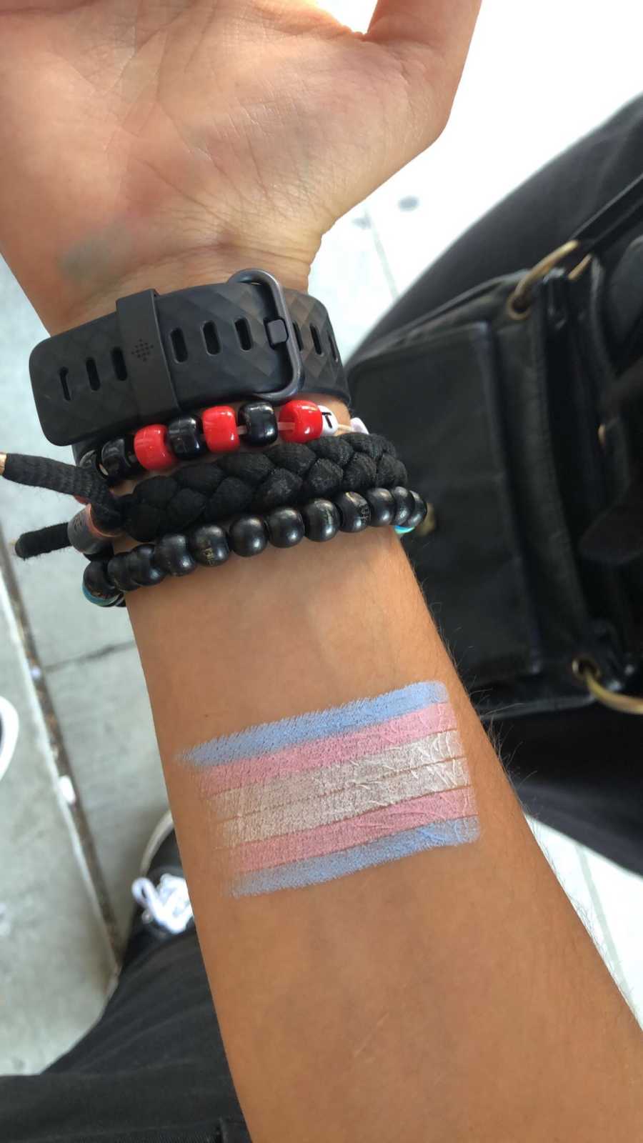 trans flag painted on a wrist