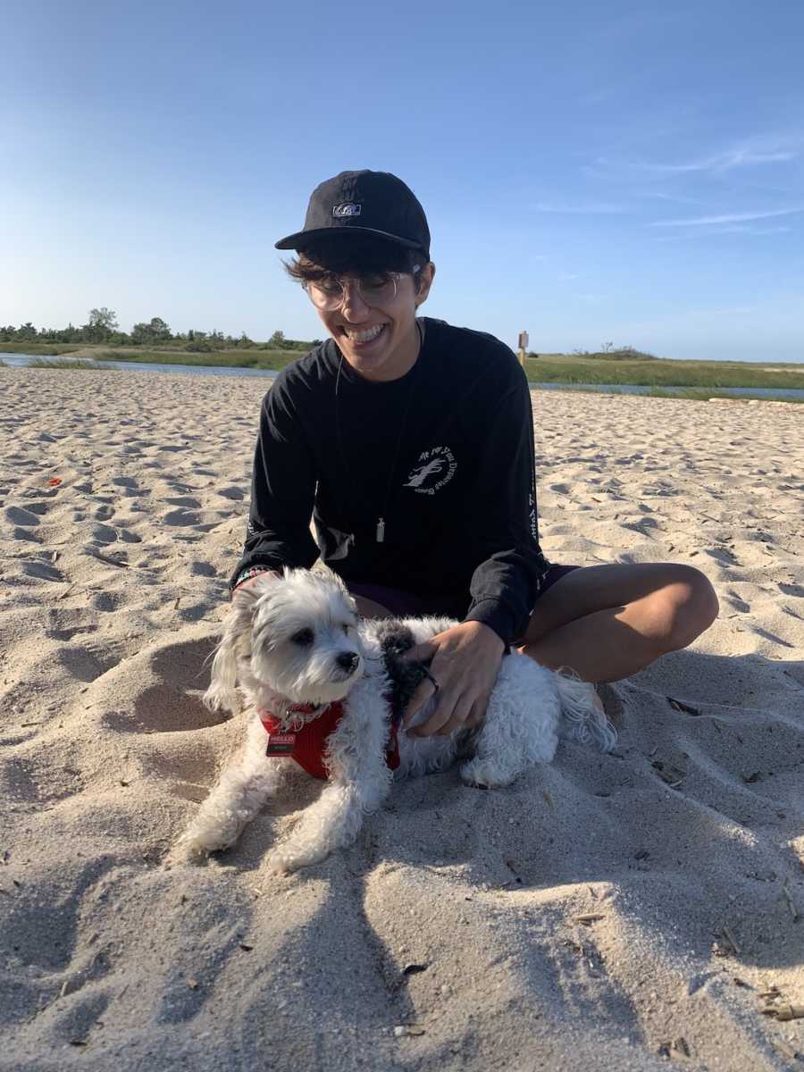 person on beach with dog