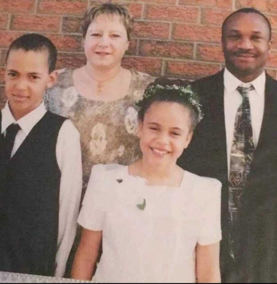 girl in Communion dress with family