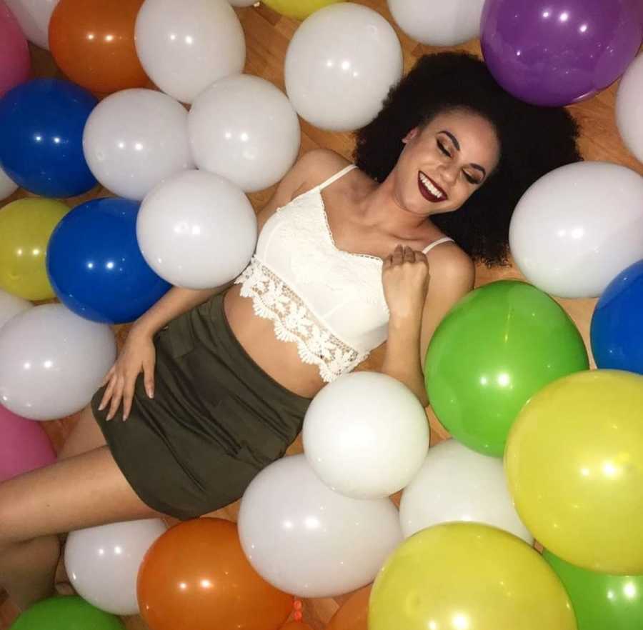 woman laying down with balloons