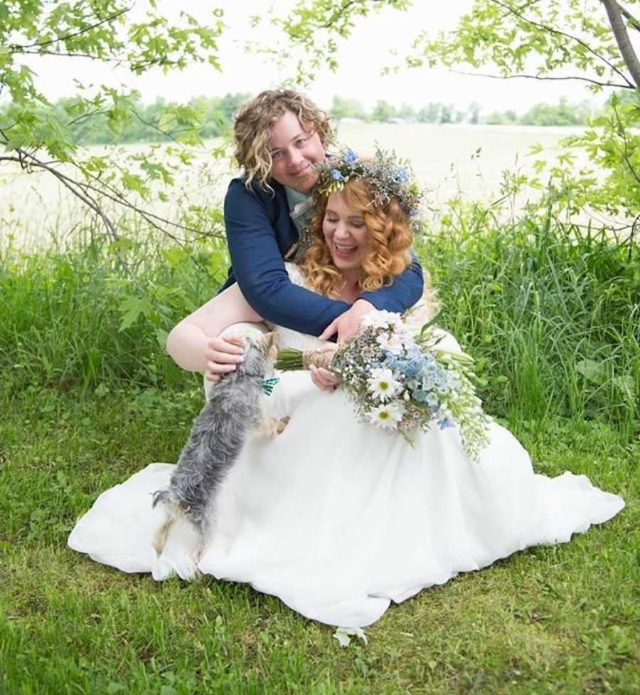 lesbian couple on wedding day by a lake