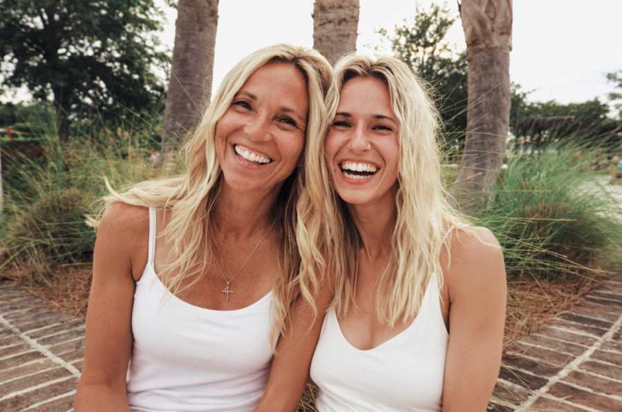 Christian mom and daughter take photo in matching white tank tops 