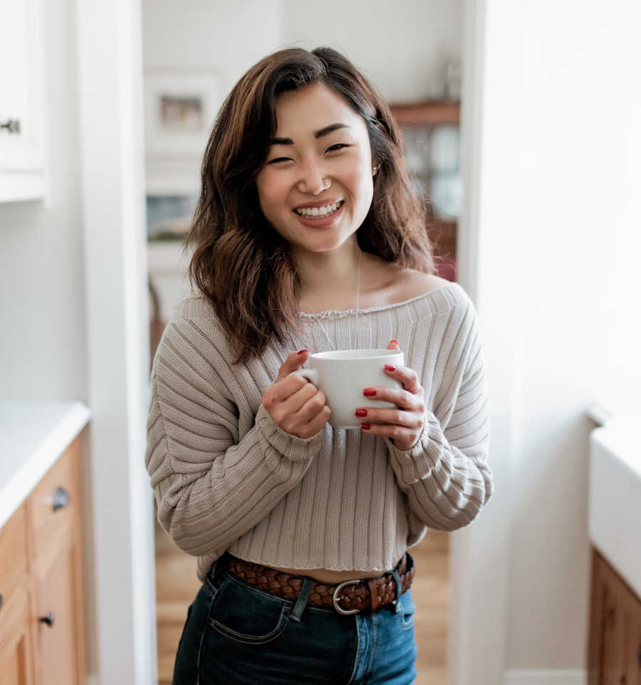 woman holding mug and smiling