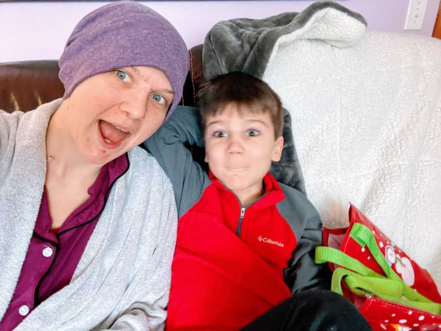 Mom battling breast cancer takes a selfie with her five-year-old son while they cuddle on the couch