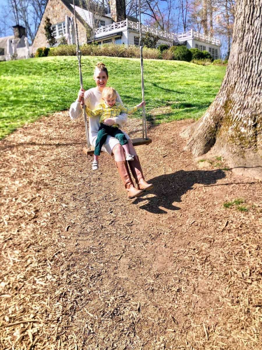 Mom and son in swing outside