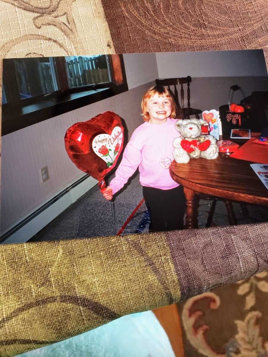 Girl holding heart shaped balloon