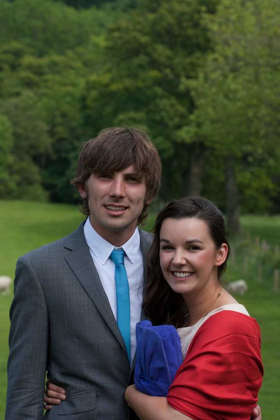 Husband and wife smiling together standing outside