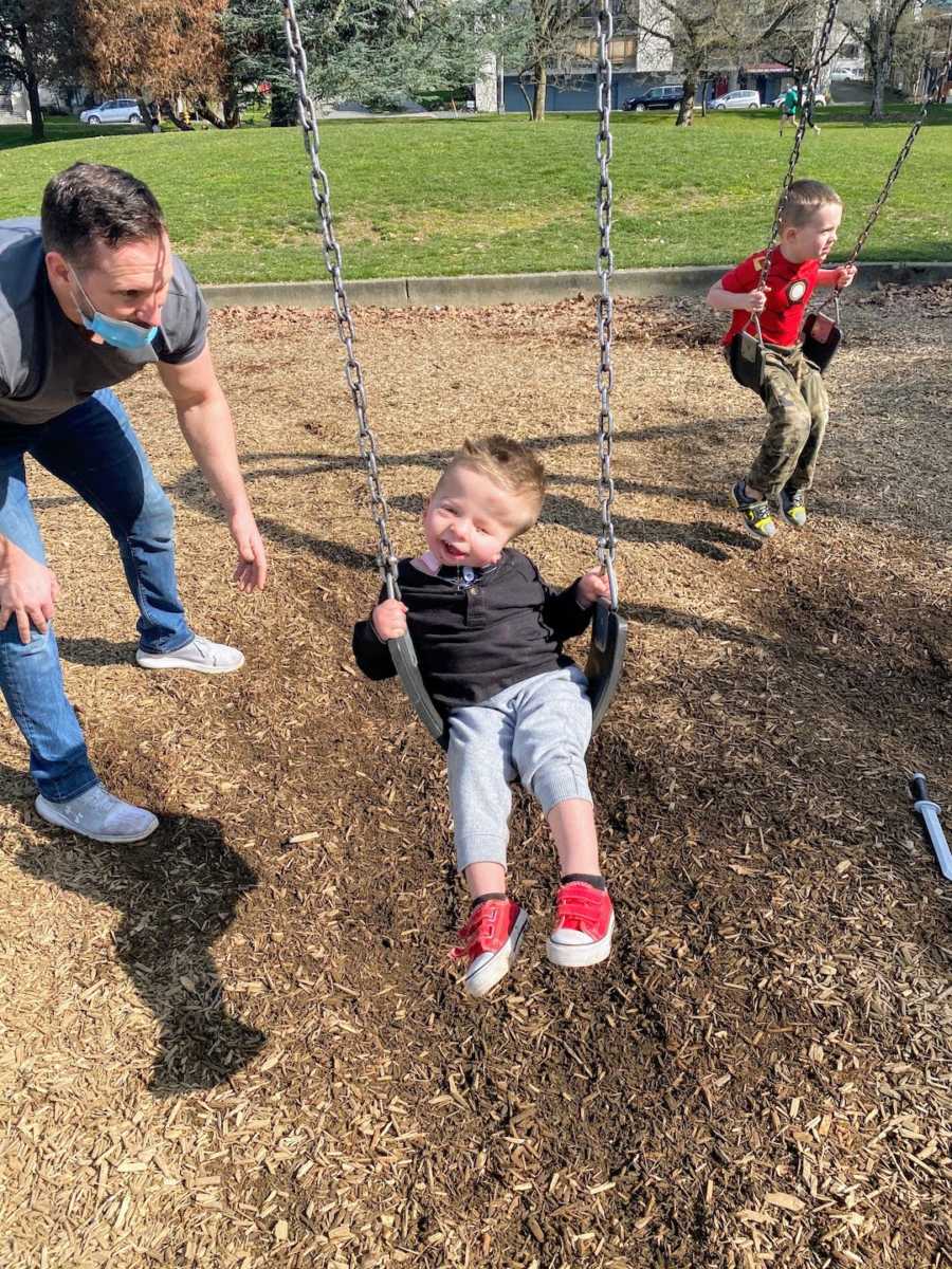 Young boy on swings at playground