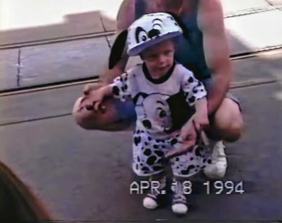 Young boy standing with mother wearing Disney's 101 Dalmations outfit