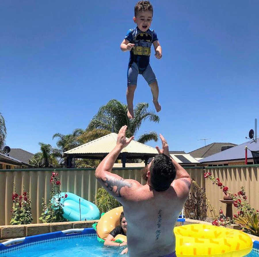 Father in pool with son