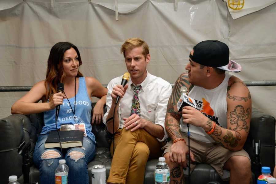 Radio host interviewing two men sitting on couch