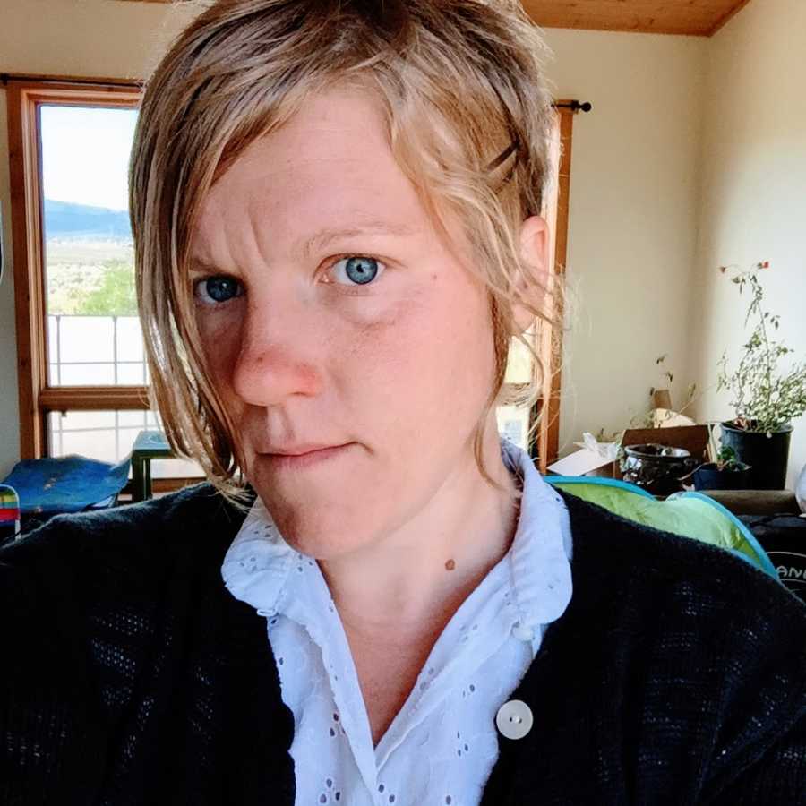 A woman with autism wearing a blue buttoned shirt