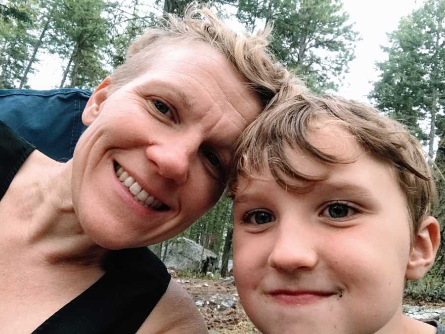 An autistic mom and her son in the woods