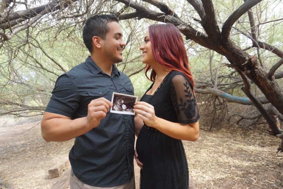 Married couple holding up ultrasound images