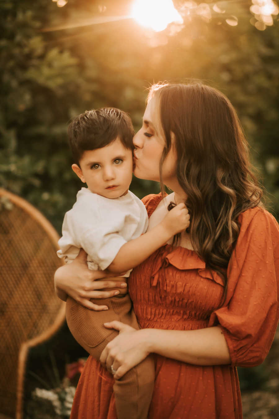 Mom kissing son on cheek