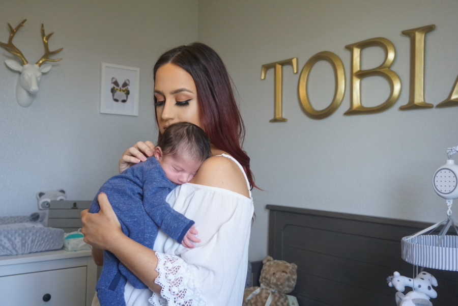 Mom holding son against chest