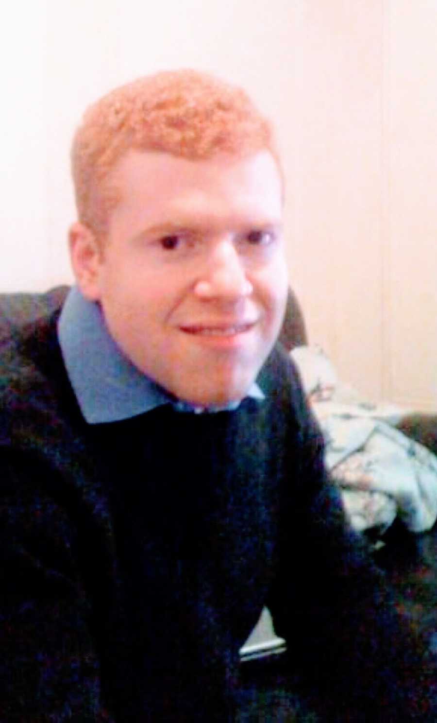 A young man with social anxiety sitting on a couch