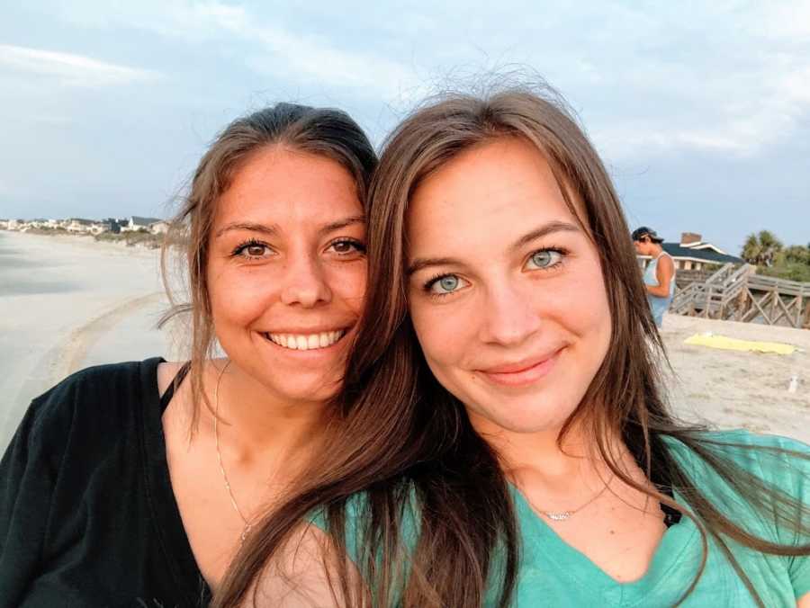 A young woman and her adopted sister on a beach