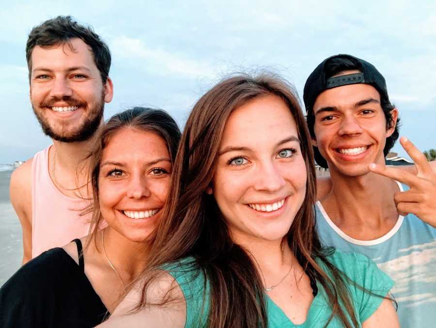 A young woman with her siblings on a beach