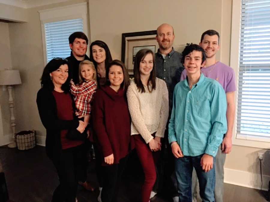 A family with eight children stand together for a picture