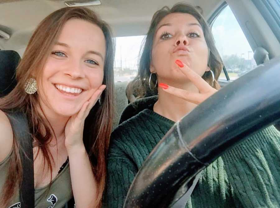 A young woman and her sister making fun faces in a car