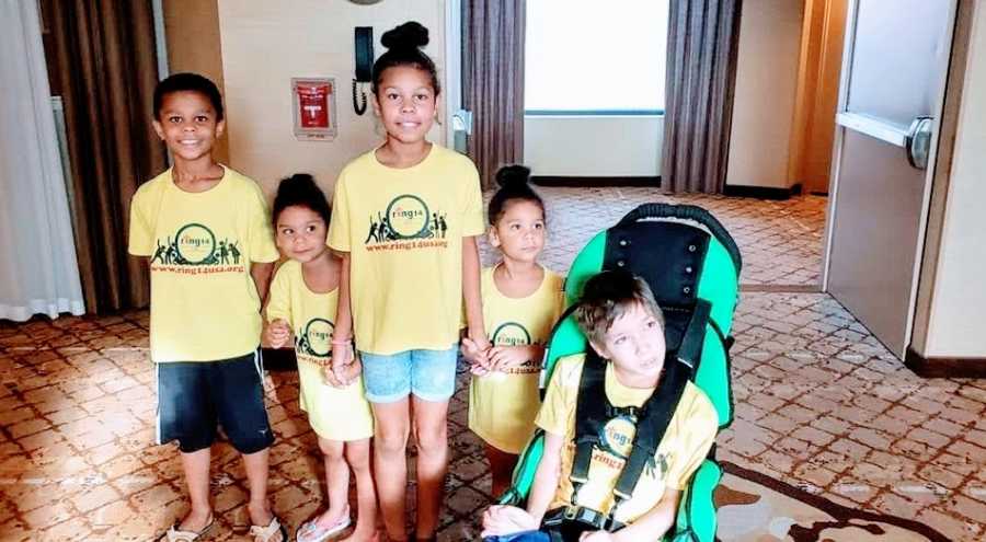 A boy with rare seizures sits with his four younger siblings, all wearing matching shirts