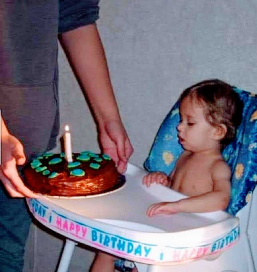 A boy with rare seizures sits in a high chair on his birthday