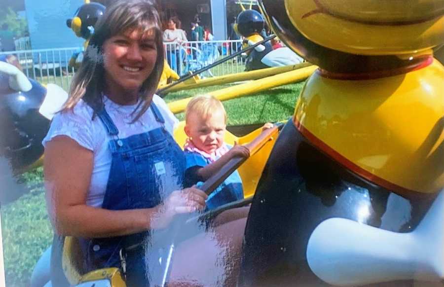 Mom riding amusement park ride with baby daughter