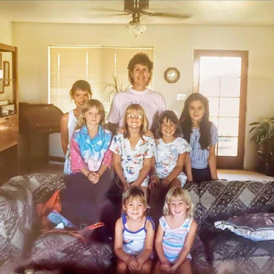 Woman standing with young family members in a living room