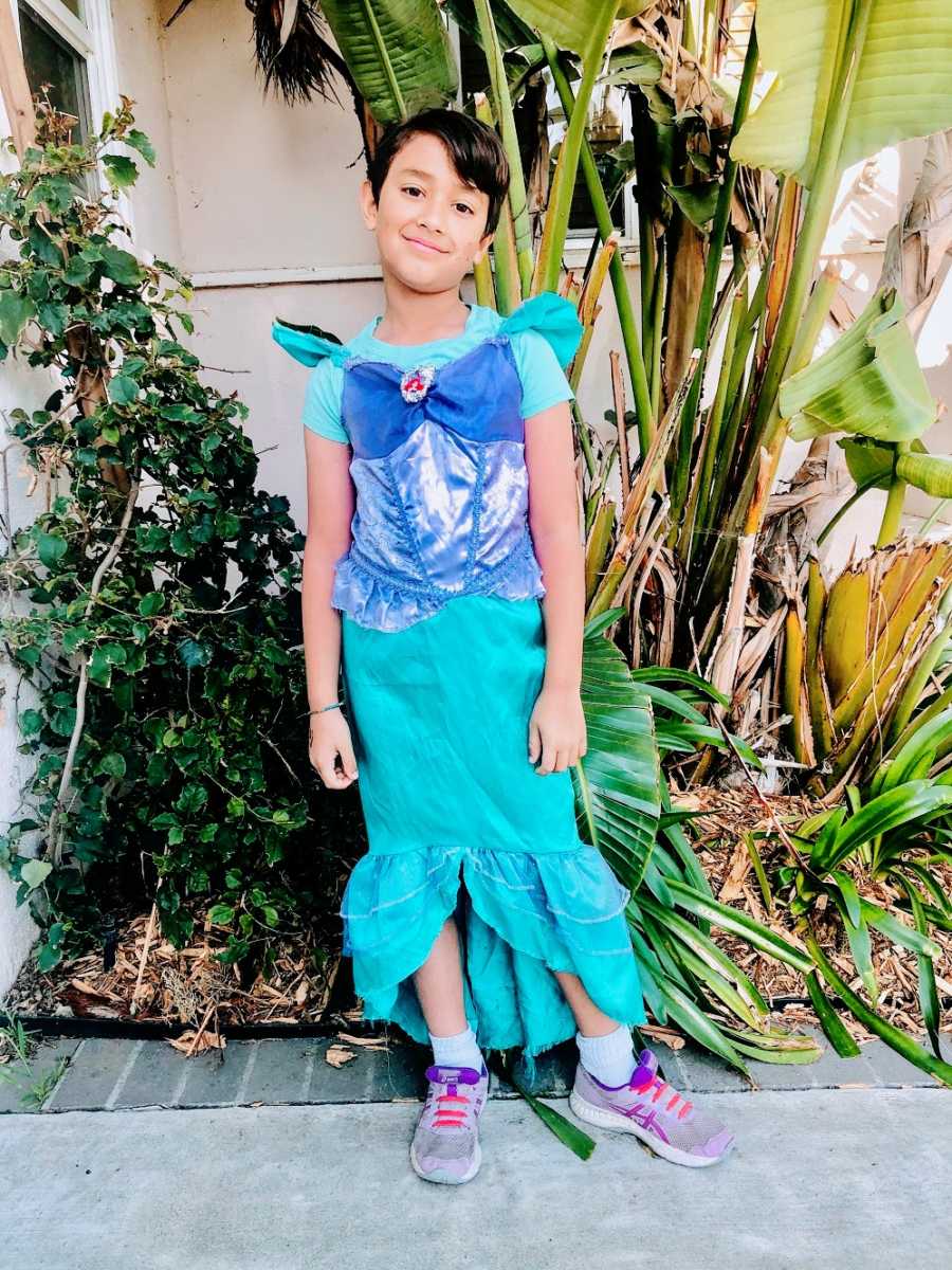 A boy wearing a mermaid costume