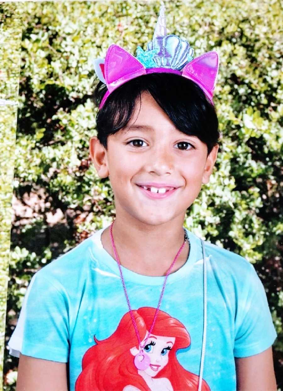 A boy wears a Little Mermaid shirt for his school picture