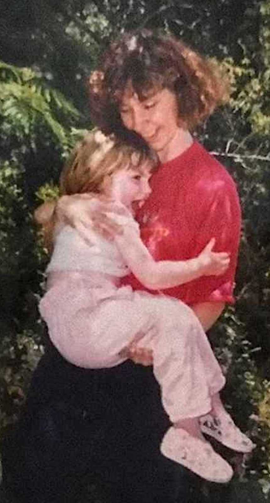 Mom holding daughter