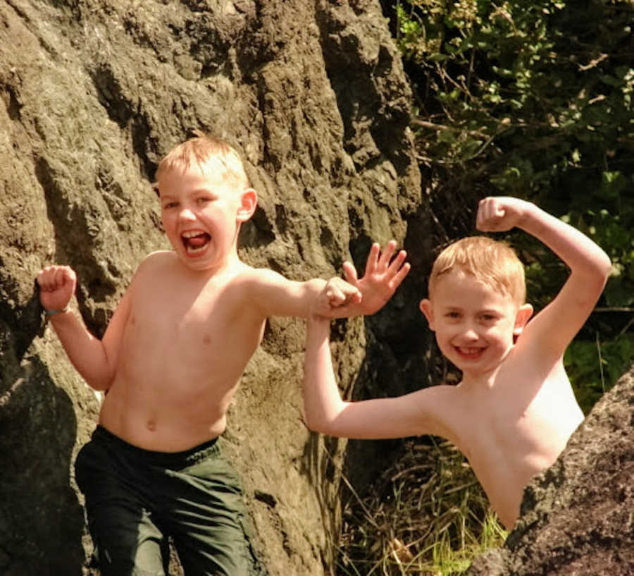 Two brothers after swimming doing funny poses