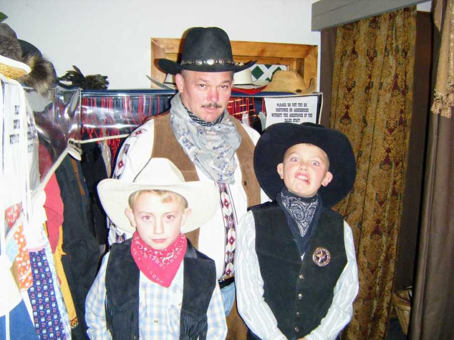 Father and sons dressed as cowboys