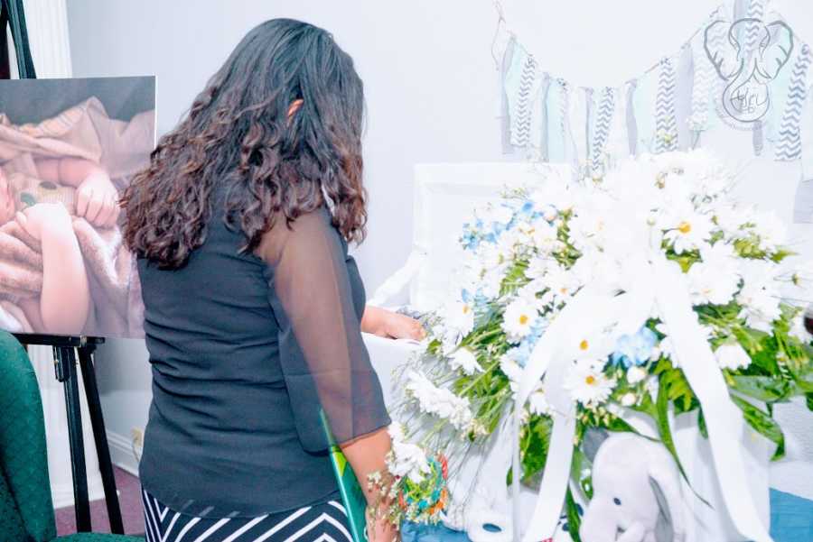 A single mother by choice grieves her stillborn son at his funeral